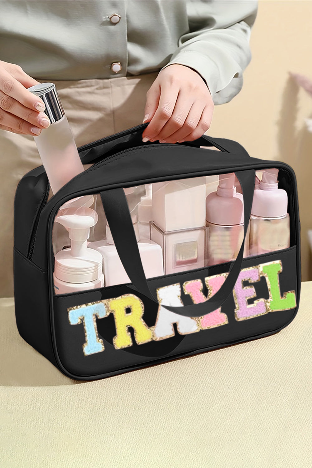 Bolsa de maquillaje de PVC transparente con letras de chenilla de TRAVEL negra